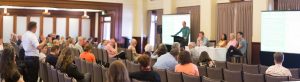 Prof Marcus Foth asks a question of the panel, L-R Chair Chris Twomey, Rod Lamberts, Benedetta Brevini, Julie Macken, Mark Chenery