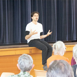 Genocide, Ecocide, Omnicide - Talking The Holocaust And Climate Action - Green Institute - Image of Tim Hollo talking to a group of people