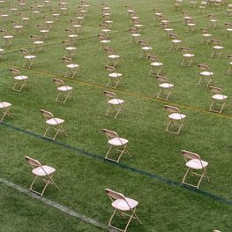 Image Description: Lots of chairs on a green field, distanced apart from each other. Together? Apart? Where ARE we?? Green Institute Webinar